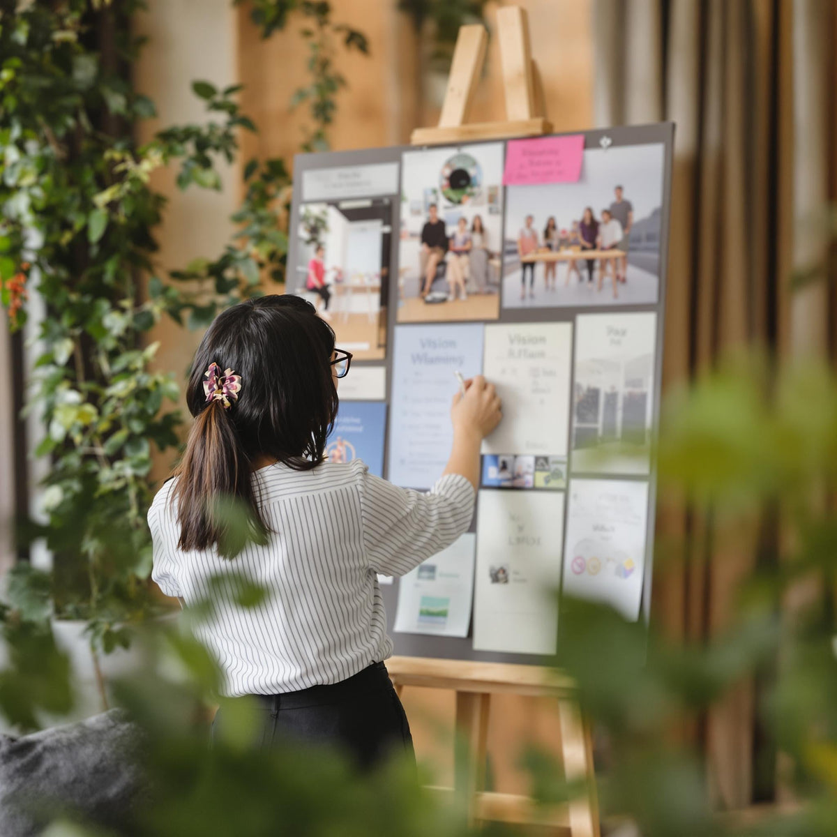 A girl doing vision planning in a planner 